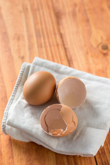Egg and eggshell on the kitchen tablecloth in the natural moody light