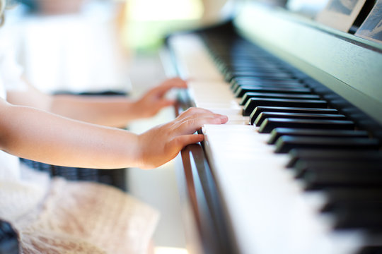 girl's hand playing piano. music, kid, piano key, leisure.