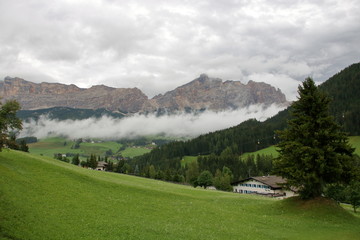 Fototapeta na wymiar Misty and cloudy alpine landscape