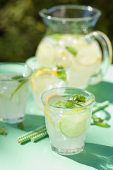 refreshing lemonade drink with mint lime lemon in garden