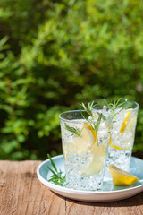 refreshing lemonade drink with rosemary in glasses