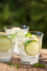 refreshing lemonade drink with mint lime lemon in garden