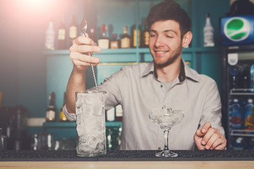 Bartender making ice for cocktail closeup