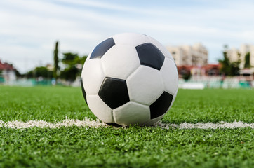 Fototapeta premium Soccer Football on the green grass of Soccer field.