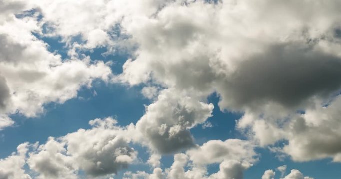 Time lapse clip of white fluffy curly rolling clouds