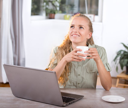 Young Woman Daydreaming In Office