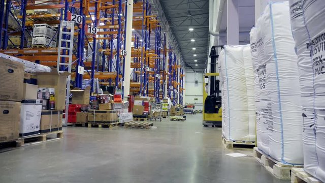 Timelapse of a huge warehouse during a working day.