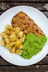 Breaded Haddock Fillet With Parmentier Potatoes And Pea Puree