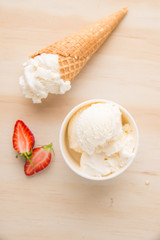 Ice Cream Scoop On Wooden Background Bowls and cones