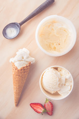 Ice Cream Scoop On Wooden Background Bowls and cones