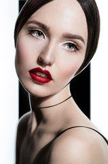 Closeup fashion portrait of model with bright red lips, on black and white background