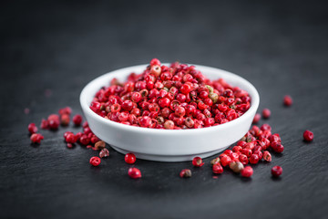 Rustic slate slab with Pink Peppercorns, selective focus