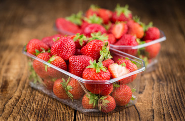Strawberries on wooden background; selective focus