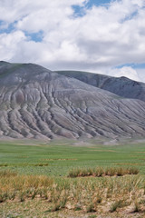 Mongolian mountain natural landscapes with eroded foothill slopes near lake Tolbo-Nuur in north Mongolia