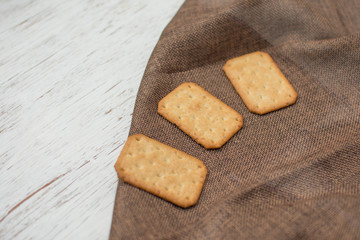 Homemade thin crispy cheesy crackers with sesame seeds in rustic wooden,Dry thin crackers
