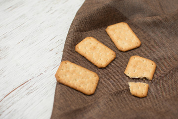 Homemade thin crispy cheesy crackers with sesame seeds in rustic wooden,Dry thin crackers