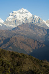 Fototapeta premium Vertical image of mountain peak in Himalayas on blue sky background, Nepal