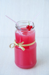 On beige background, a red currant drink