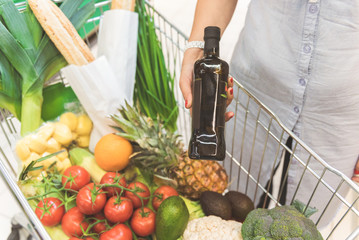 Woman arm laying purchase to vegetables