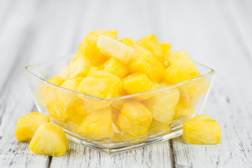 Portion of Pineapple (sliced) on wooden background, selective focus