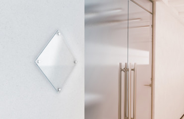 Blank rhombus transparent glass sign plate mockup, 3d rendering. Nameplate mock up on the wall near...