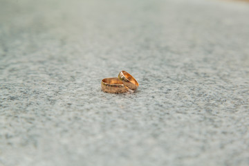 Gold wedding rings on the texture