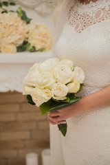 Morning of the Bride. Excitement before the wedding. The bride is holding a wedding bouquet