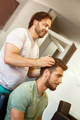 Fototapeta premium Hairdresser fixing hair of model