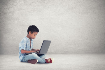 Little boy using  laptop