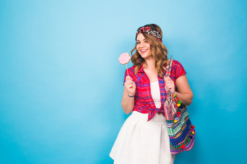 young woman in hippie style posing at studio. Fashionable photo.