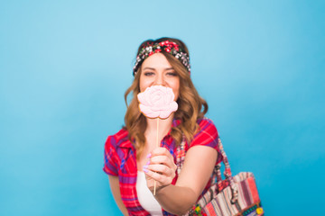 Obraz premium young woman with the colorful lollipop at studio with copy space