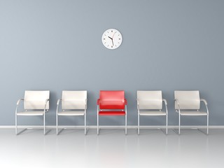 One red chair between white chairs in the waiting room