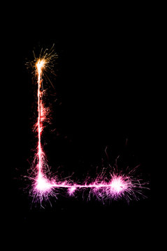 English alphabet from sparkler on black background,Alphabet big letter