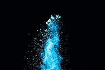 Abstract blue powder splatted on white background. Freeze motion of blue powder exploding on black background