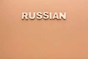 Word Russian on beige background
