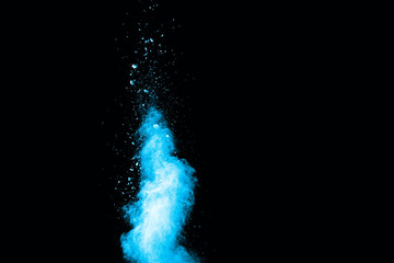 Abstract blue powder splatted on white background. Freeze motion of blue powder exploding on...