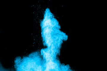 Abstract blue powder splatted on white background. Freeze motion of blue powder exploding on...