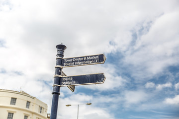 Signs on a street showing the way to the city center