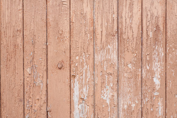 Part of an old wooden fence with peeled paint, abstract texture