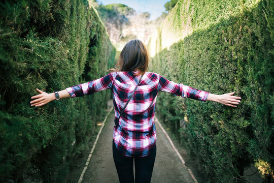 Young Woman Walking In The Park Labyrinth