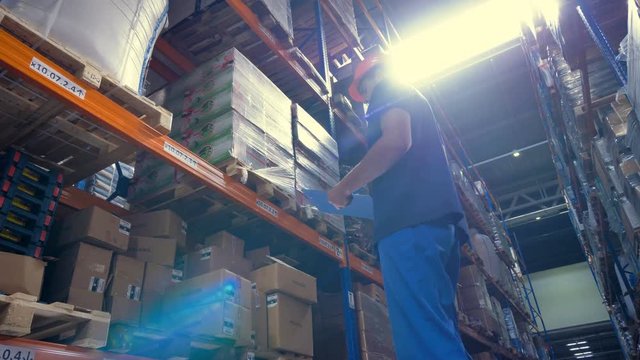 A storage facility cargo taking notes on wide range of stored goods.