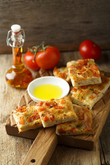 Homemade bread with tomatoes, herbs and olive oil