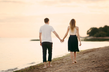 Young happy couple on seashore