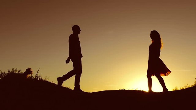 Man and Woman love silhouette in sunset slow motion video. Couple in love kissing at sunrise family silhouette. married couple
