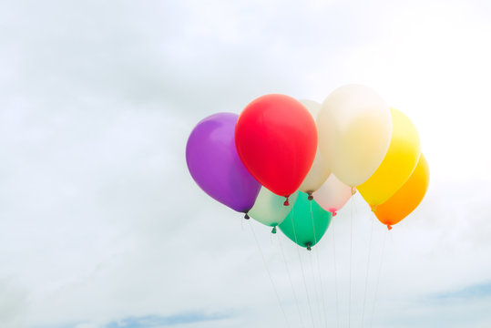 Lots of colorful balloons on the blue sky, concept of love in summer and valentine, wedding honeymoon. Vintage effect style pictures.