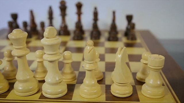 dolly, tracking shot of a chess party. White against black. Backlash