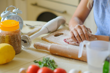 close up hands of young woman with flour