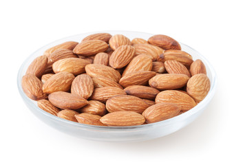 Almonds in glass bowl isolated on white background