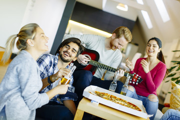 Group of young people having pizza party