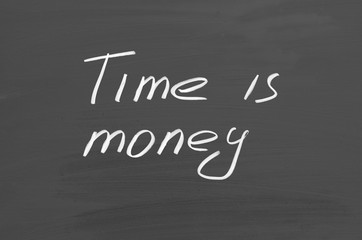 Time is money. Text on chalkboard